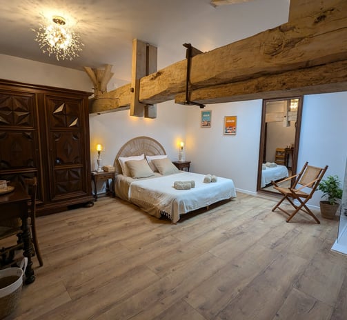 a bedroom with a bed and a chair