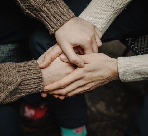 a group of people holding hands together