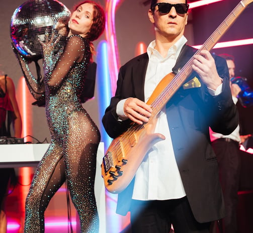 a man and woman in a bodysuits and sunglasses