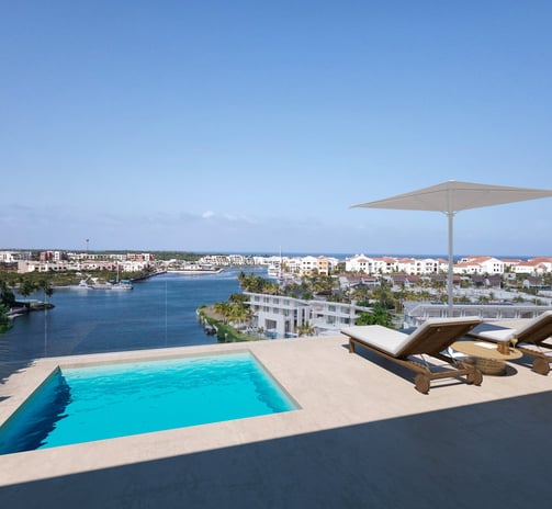 a pool with a lounge chair and a view of the ocean