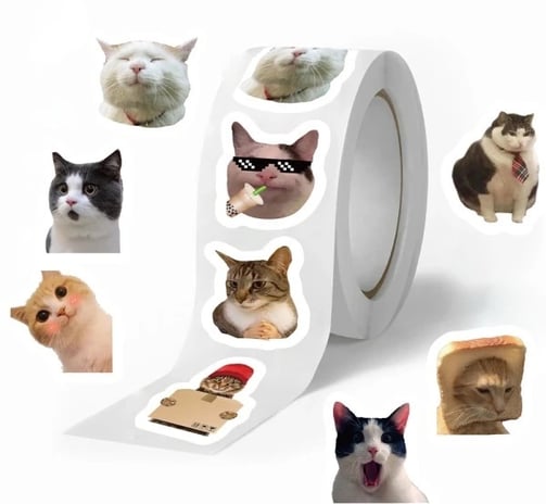 a roll of stickers with a meme cat on it