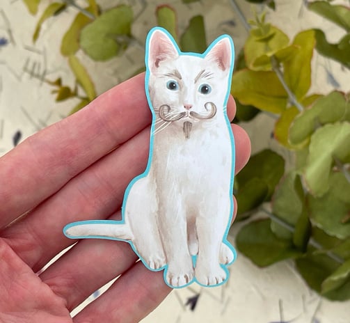 a white cat sticker with moustache