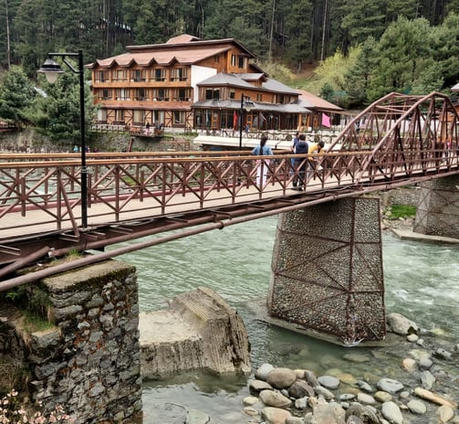 A 5 star Hotel with a bridge with a bridge over a river