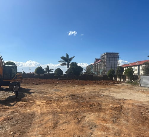 a construction worker is standing in front of a construction site