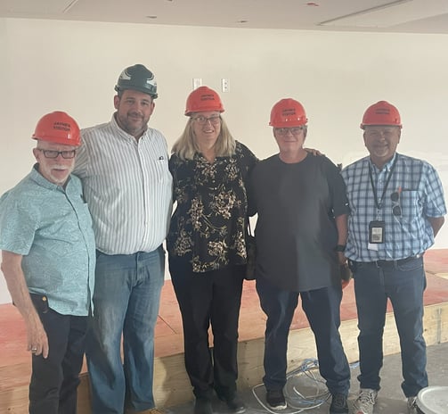 DCC members wearing hard hats at Pah Apartments construction site