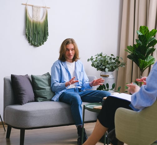 a woman sitting on a couch in a living room