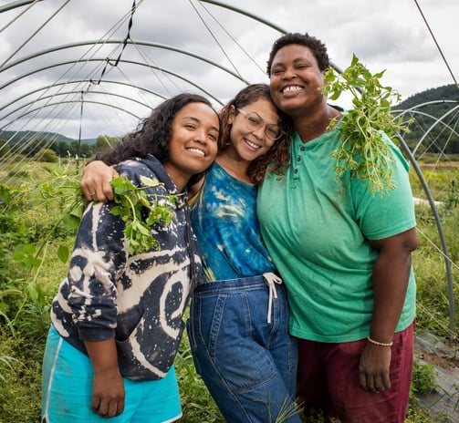 a group of people standing in a garden