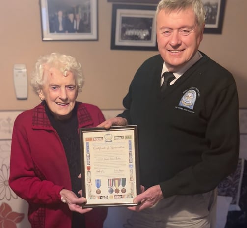 John presenting a Congo Commemorative scroll to the Mullins Family