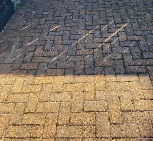 outdoor cleaning services Fife - a yellowish orange bricked driveway, half clean, half dirty