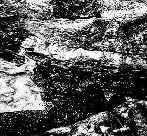 Recycled plastic collage texture in black and white image 