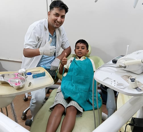 Dr Barun Kant dentist with child after dental treatment at Rps Dental Clinic in Ranchi