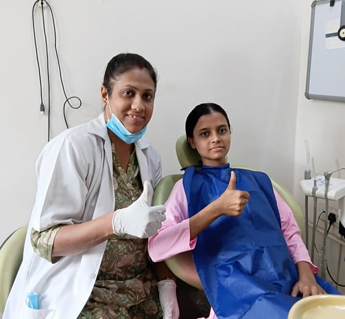 Dr Kamana Vijay Rai dentist at Rps Dental Clinic smiling with happy dental patient