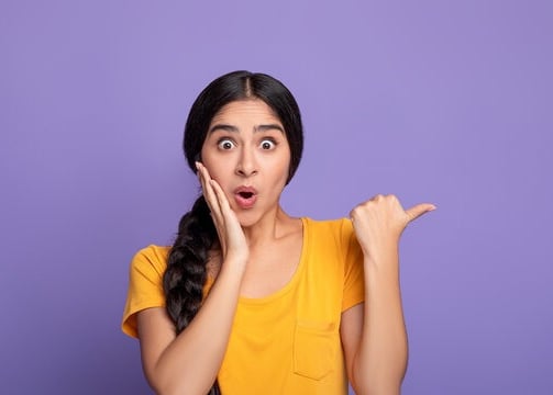 a woman with a surprised Lanka ads look on her face and holding her hands up to her
