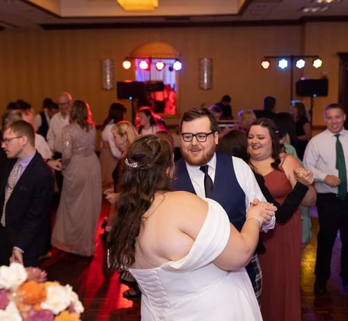 a bride and groom dancing at their wedding reception