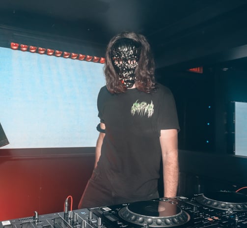a man in a black shirt and a dj booth