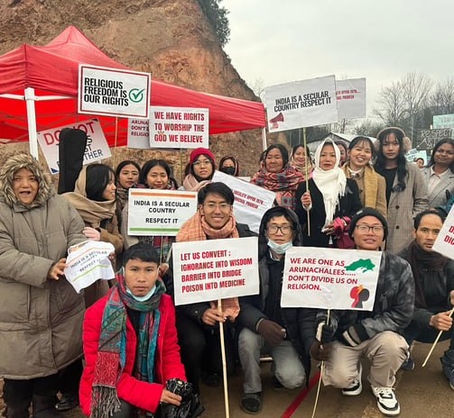 a group of people holding signs and holding signs