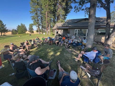 a group of people sitting in chairs in a circle