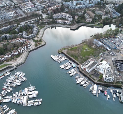 a cityscape of a harborfront with boats and buildings