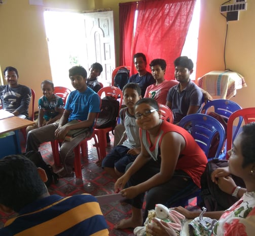 a group of people sitting around a table
