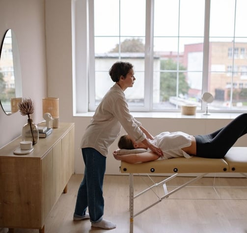 A woman getting a physio massage in her home. The London Physio