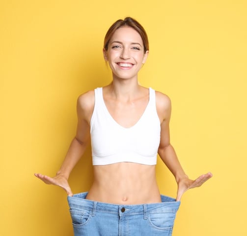 a woman in a white bra top and jeans jeans