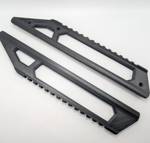 a pair of black plastic pegs on a white background