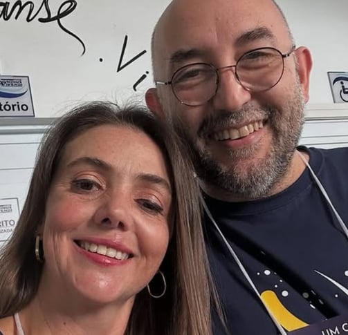 a man and woman smiling and posing for a picture