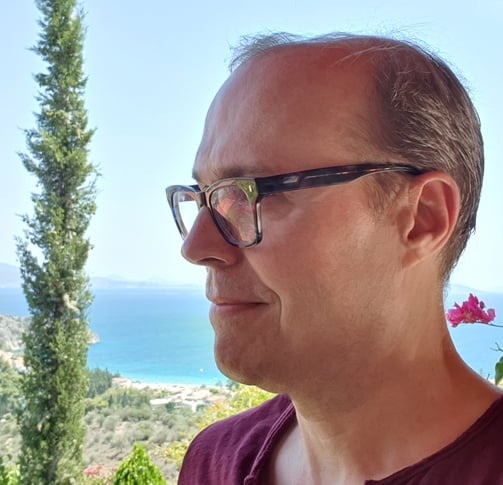 a man in a red shirt and glasses
