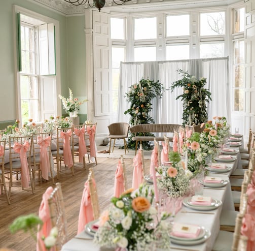 a long table with a bunch of flowers on it