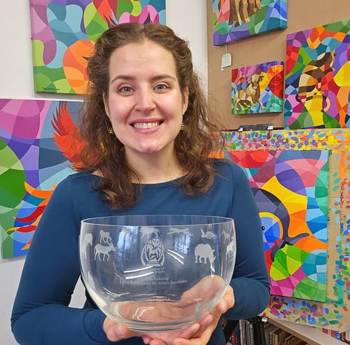 Award winning artist Tanja Hassel smiling proudly, holding Pollyanna Pickering award