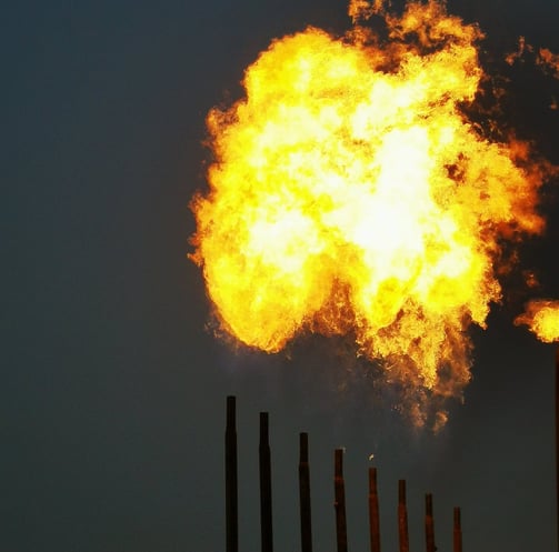 a large explosion of yellow flames in a field