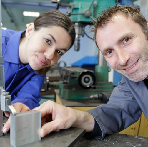 a man and woman in a factory shop
