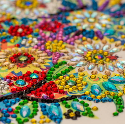 a close up of a colorful embroided rhinestone on a table