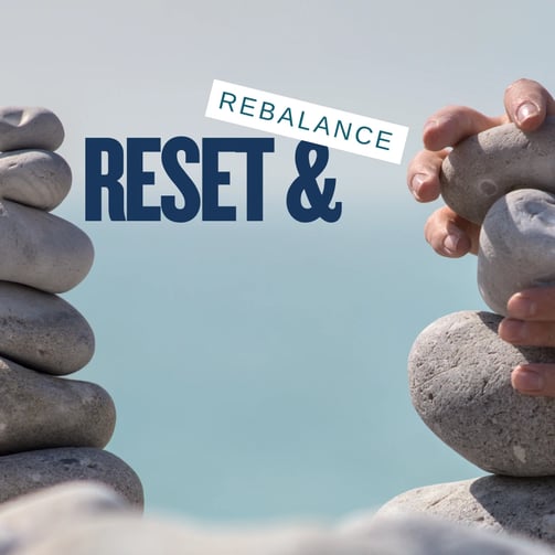 two piles of stones either side of a blue background with Reset and rebalance written in the gap between the piles