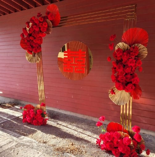 gold chrome backdrop with red roses and a double happiness sign for rent