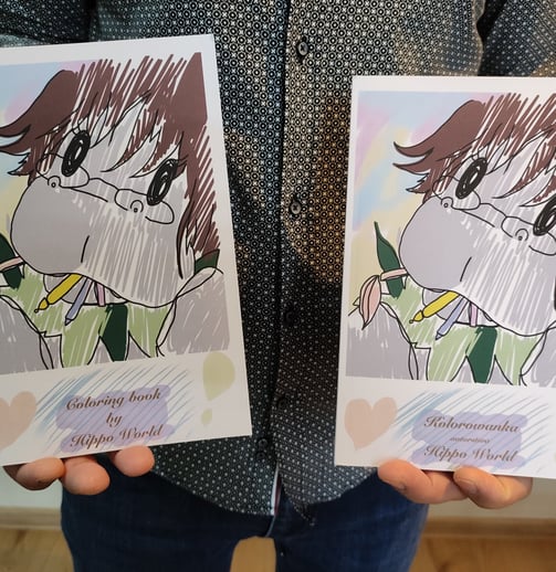 a man holding two books with a drawing of a girl