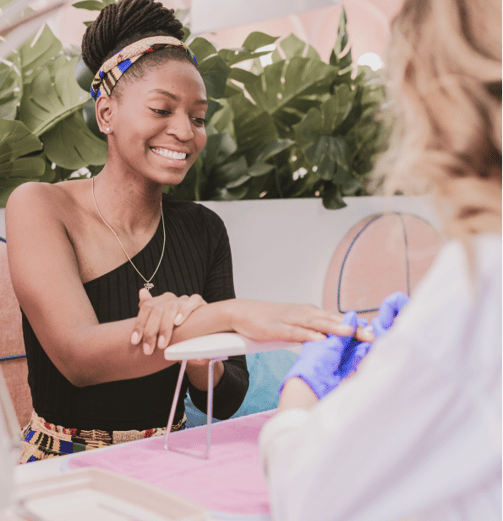 A smiling lady enjoying a manicure session