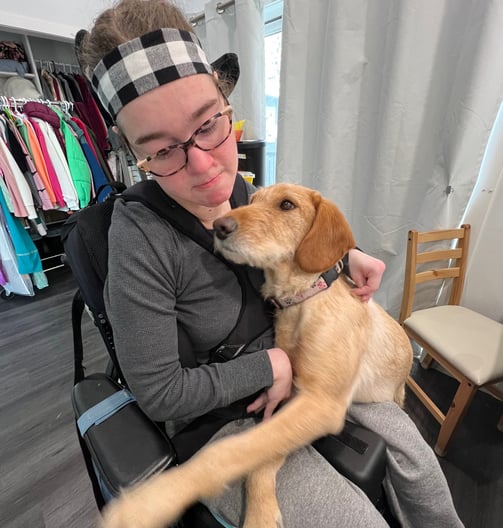 a woman in a wheelchair with a dog in a wheelchair