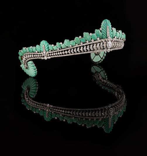 Angled view of Nancy Astor’s Cartier turquoise and diamond tiara with reflection on black surface.