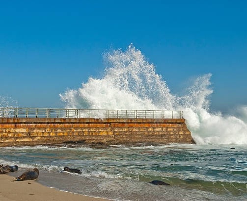 water splashing on seawall