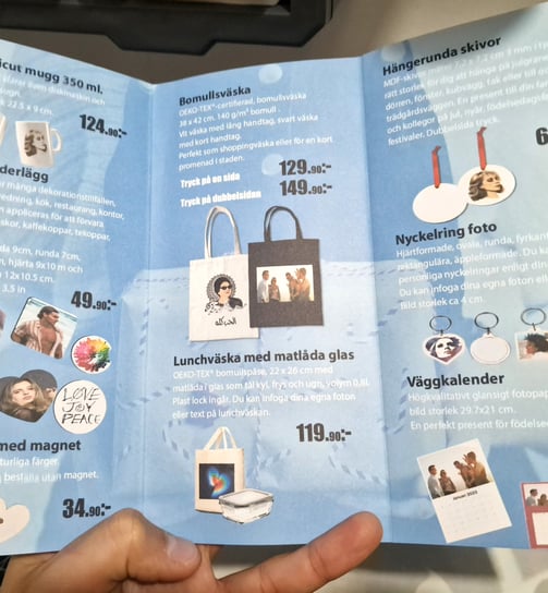 a person holding a book with pictures of a person holding a bag