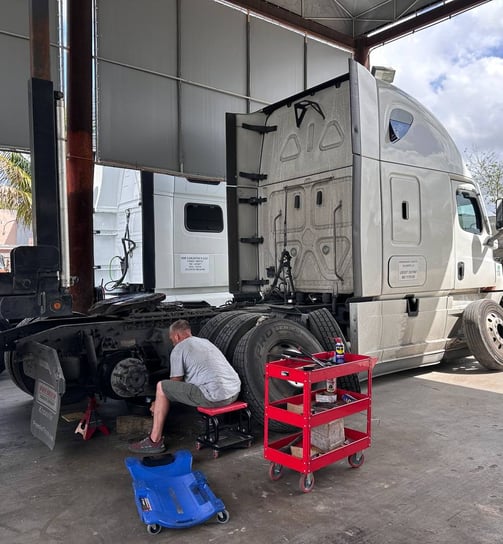 Professional technician at work fixing semi truck 