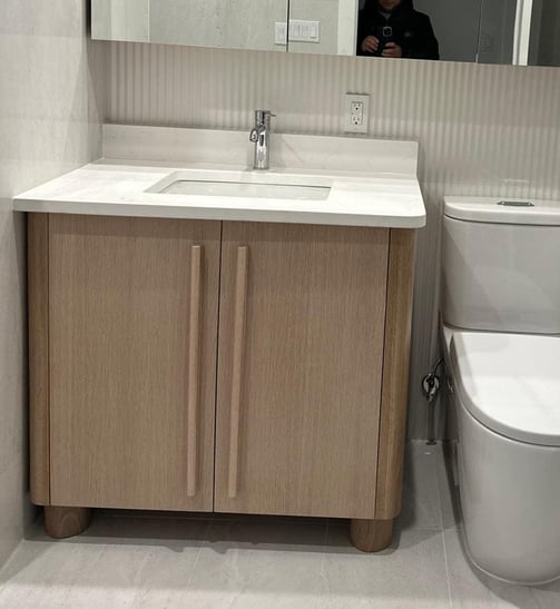 a bathroom with a toilet and a mirror