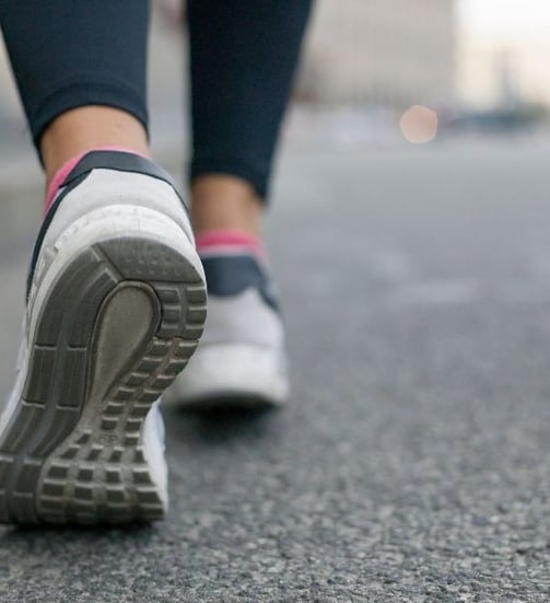 a person walking on a sidewalk