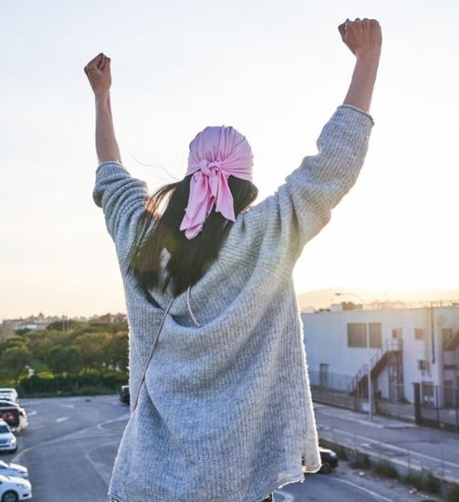 a woman with a pink scarf around her neck