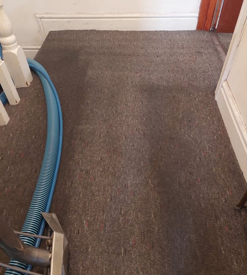 heavy soiled landing with sticky foot traffic in the process of deep cleaning in Leeds