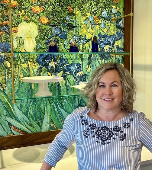 Woman posing in front of stained glass.