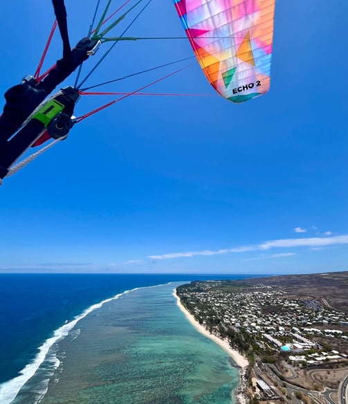 a person parasailing over a body of water