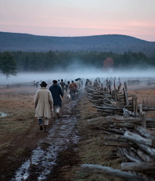 Soft dawn mist over dense pine forest reveals Fort Necessity’s hastily erected log palisades