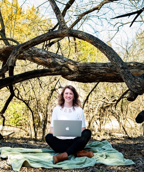 girl in woods with laptop